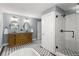Luxurious bathroom featuring dual sinks, soaking tub, and glass-enclosed shower at 2732 Arbor Se Ave, Atlanta, GA 30317
