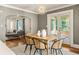 Bright dining area with modern light fixture, wood table, and woven chairs, flowing into a living space at 2732 Arbor Se Ave, Atlanta, GA 30317