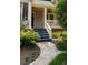 Inviting front porch with stone walkway, blue stairs, and white railings, perfect for relaxing at 2732 Arbor Se Ave, Atlanta, GA 30317