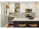 Updated kitchen with stainless steel appliances, quartz countertops, and white cabinets with gold accents at 2732 Arbor Se Ave, Atlanta, GA 30317
