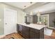 Modern kitchen island with sleek countertops, a wine fridge and bar stools with adjacent dining area at 2732 Arbor Se Ave, Atlanta, GA 30317