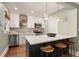 Bright and updated kitchen with stainless steel appliances, a center island with barstool seating, and stylish lighting at 2732 Arbor Se Ave, Atlanta, GA 30317