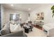 Open living area with hardwood floors, fireplace, and dining room access, enhanced by natural light and stylish decor at 2732 Arbor Se Ave, Atlanta, GA 30317
