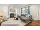 Bright living room with fireplace, neutral colors, hardwood flooring, and large windows with patterned drapes at 2732 Arbor Se Ave, Atlanta, GA 30317