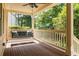 Relaxing covered porch with ceiling fan and comfortable swing, ideal for enjoying the outdoors at 2732 Arbor Se Ave, Atlanta, GA 30317