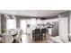 Open kitchen and dining area features white cabinets, stainless steel appliances, and breakfast bar seating at 40 Alameda St # 131, Loganville, GA 30052