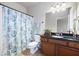 Well-lit bathroom featuring granite counters, vanity with sink, and shower with decorative shower curtain at 4206 Mastic Pt # 24, Acworth, GA 30101