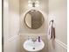 Charming powder room with pedestal sink, decorative mirror, and beadboard wainscoting at 4206 Mastic Pt # 24, Acworth, GA 30101