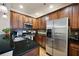 Modern kitchen with stainless steel appliances, granite countertops, and rich wood cabinetry at 4206 Mastic Pt # 24, Acworth, GA 30101
