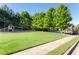 Community playground with swingset and playhouse on a large grassy field near the pool at 4206 Mastic Pt # 24, Acworth, GA 30101