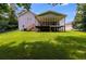 Expansive backyard featuring a screened porch, deck, and plenty of green space at 1876 Kathy Ct, Douglasville, GA 30135