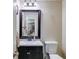 Half bath with framed mirror and modern fixtures at 1876 Kathy Ct, Douglasville, GA 30135