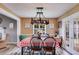Cozy dining room with whimsical chandelier and views to the exterior at 1876 Kathy Ct, Douglasville, GA 30135