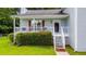 Inviting front porch with white railing, partial seating and an entrance into the home at 1876 Kathy Ct, Douglasville, GA 30135