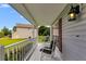 Charming front porch featuring white railing, comfortable seating, and a view of the front yard at 1876 Kathy Ct, Douglasville, GA 30135