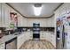 Bright kitchen featuring white cabinets, granite countertops, stainless steel appliances and wood floors at 1876 Kathy Ct, Douglasville, GA 30135