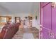 Living room featuring hardwood floors, view of dining room, and a purple front door at 1876 Kathy Ct, Douglasville, GA 30135