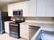 Bright kitchen featuring modern appliances, sleek white cabinets, and countertops, offering a clean and functional cooking space at 2917 Duncan Pl, Decatur, GA 30034