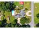 Aerial view of property featuring a pool, shed, expansive lawn, and circular driveway at 3690 Lithia Way, Lithia Springs, GA 30122