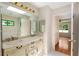 Bathroom with double sinks and vanities, tiled floor and door to Primary bedroom at 3690 Lithia Way, Lithia Springs, GA 30122