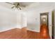 Bedroom features hardwood floors, ceiling fan, and a closet and door to the hallway at 3690 Lithia Way, Lithia Springs, GA 30122