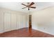 This bedroom offers ample space with wood-look floors and plenty of closet space for storage at 3690 Lithia Way, Lithia Springs, GA 30122