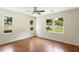 Bedroom features hardwood floors and three windows providing natural light at 3690 Lithia Way, Lithia Springs, GA 30122