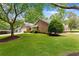 Brick home with green lawn, mature trees, and side entry garage at 3690 Lithia Way, Lithia Springs, GA 30122
