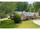 Brick home boasts a lush green lawn and well-maintained landscaping, showcasing its curb appeal at 3690 Lithia Way, Lithia Springs, GA 30122