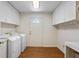 Spacious laundry room offering lots of storage, white cabinets, wood-look flooring, and a practical layout at 3690 Lithia Way, Lithia Springs, GA 30122