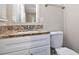 Bathroom features granite countertops, a large mirror, and a tiled backsplash at 4095 Indian Creek Cir, Stone Mountain, GA 30083