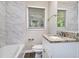 This bathroom features a vanity with granite countertop, tiled walls, and a window for natural light at 4095 Indian Creek Cir, Stone Mountain, GA 30083