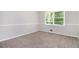 This carpeted bedroom offers neutral walls, a single window, and painted trim at 4095 Indian Creek Cir, Stone Mountain, GA 30083