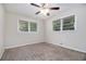 Cozy bedroom with neutral carpet, ample natural light, and a ceiling fan at 4095 Indian Creek Cir, Stone Mountain, GA 30083