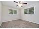 Bedroom featuring a ceiling fan, two large windows, and plush carpeting at 4095 Indian Creek Cir, Stone Mountain, GA 30083