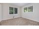 This carpeted bedroom has neutral walls and two windows providing natural light at 4095 Indian Creek Cir, Stone Mountain, GA 30083