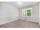 Comfortable bedroom with plush carpeting, two windows, and neutral wall colors at 4095 Indian Creek Cir, Stone Mountain, GA 30083