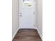 Inviting entryway features a white front door, dark wood-look flooring, and neutral walls at 4095 Indian Creek Cir, Stone Mountain, GA 30083