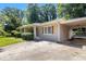 Stylish home featuring neutral paint, shutters, a covered carport, and a well-maintained driveway at 4095 Indian Creek Cir, Stone Mountain, GA 30083