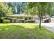 Charming ranch-style home with a well-manicured lawn and mature trees offering shade and curb appeal at 4095 Indian Creek Cir, Stone Mountain, GA 30083