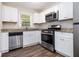 Modern kitchen featuring white cabinets, granite countertops, and stainless steel appliances at 4095 Indian Creek Cir, Stone Mountain, GA 30083