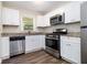 This kitchen features white cabinets, modern appliances, and granite countertops at 4095 Indian Creek Cir, Stone Mountain, GA 30083
