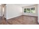 Bright, neutral living room featuring dark wood-look flooring and abundant natural light at 4095 Indian Creek Cir, Stone Mountain, GA 30083
