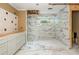 Bathroom remodel showcasing white marble tile shower, new vanity, and new flooring at 5271 Oglethorpe Ct, Powder Springs, GA 30127
