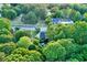 Drone shot of the home surrounded by lush, mature trees showing the neighborhood at 1784 Virginia Grove Ln, Lawrenceville, GA 30045