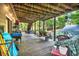 Covered back deck with stairs to the yard, great for relaxing or entertaining guests at 1784 Virginia Grove Ln, Lawrenceville, GA 30045
