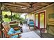View of back porch with seating, rug, ceiling fan, and access to backyard at 1784 Virginia Grove Ln, Lawrenceville, GA 30045