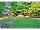 Spacious backyard featuring a grassy area and a charming shed at 1784 Virginia Grove Ln, Lawrenceville, GA 30045