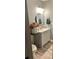 Bathroom featuring stylish gray walls, updated vanity, mirror, and modern flooring at 1784 Virginia Grove Ln, Lawrenceville, GA 30045