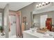 Bathroom with a double sink vanity, decorative wall art and a walk-in shower with fabric curtain at 1784 Virginia Grove Ln, Lawrenceville, GA 30045